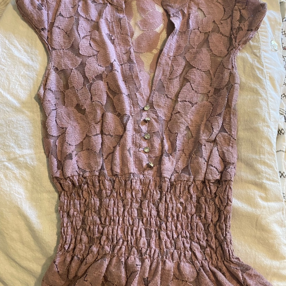 Lilac shirt, bunches at waist, small cap sleeve.